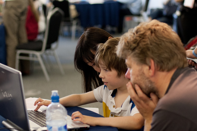 A child learns to create a game using Puzzlescript at a workshop