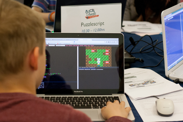 A boy learns basic coding with Puzzlescript to make a puzzle game